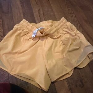 Orange lululemon low rise hotty hot size 4 shorts